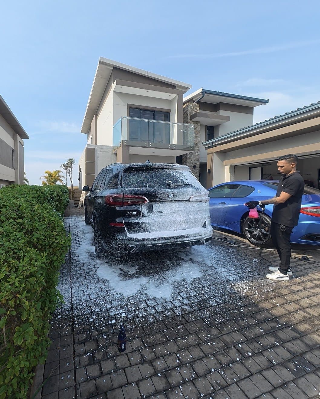 Glossify Detailing detailing a car on a driveway